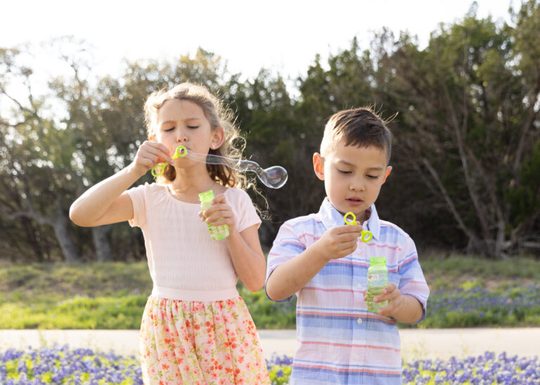 girl and boy blowing bubbles