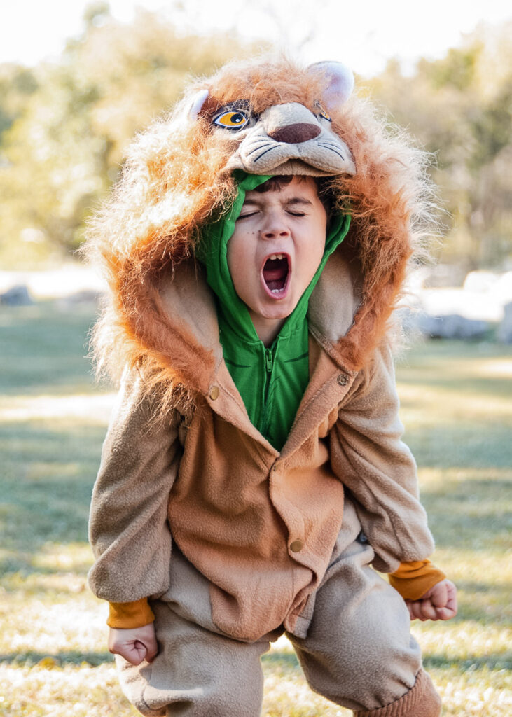boy in lion costume roaring in Austin, TX