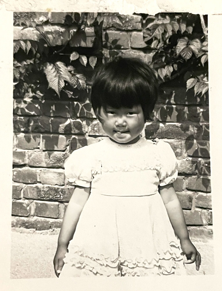 black and white of an Asian girl in a dress