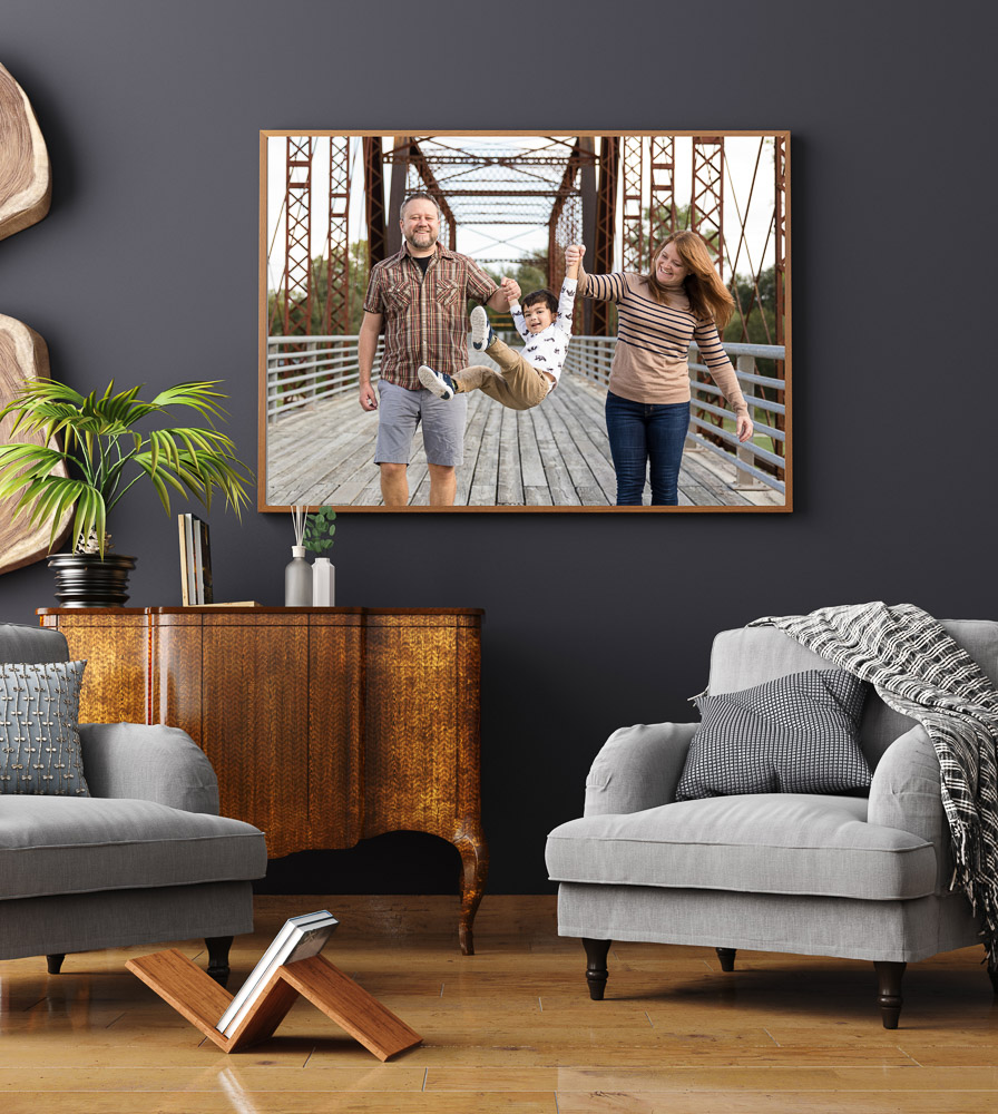 wall art portrait of a family on a bridge, swinging their boy between them in Austin