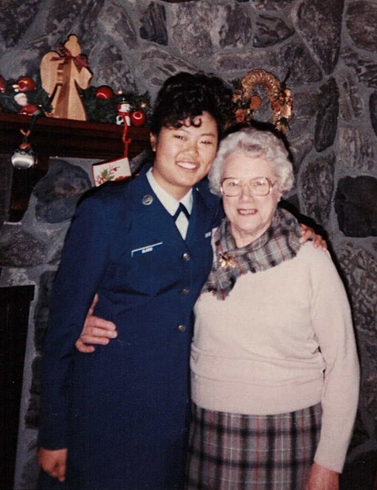 Woman in Air Force uniform hugging her grandmother.