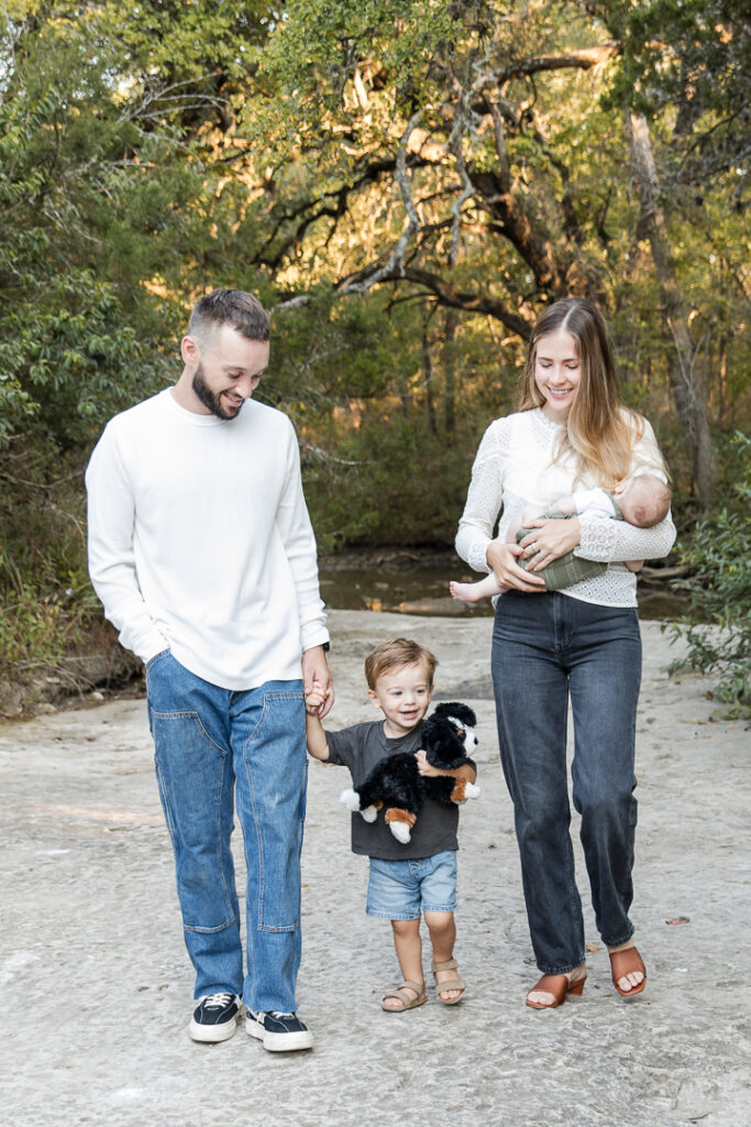 Young family with toddler and baby enjoying a walk together in Austin.