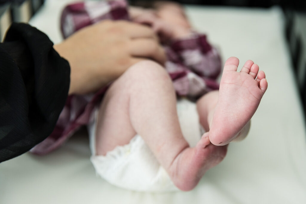 Close up of newborn baby feet during lifestyle in-home newborn photography in Austin