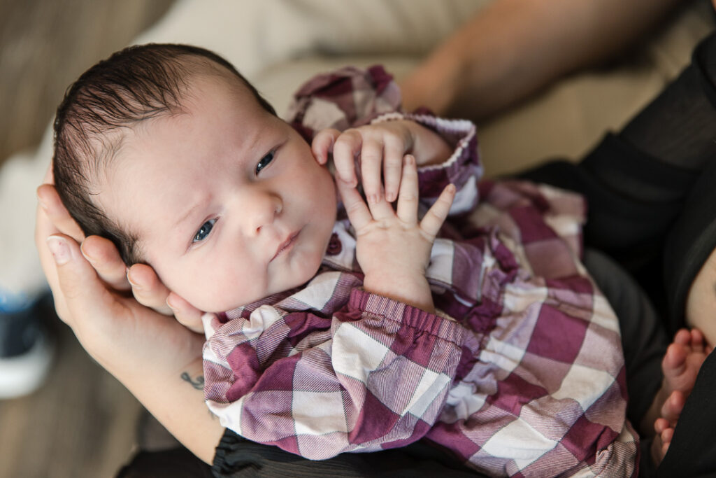 Newborn baby resting on parent during in-home newborn photography session in Austin TX